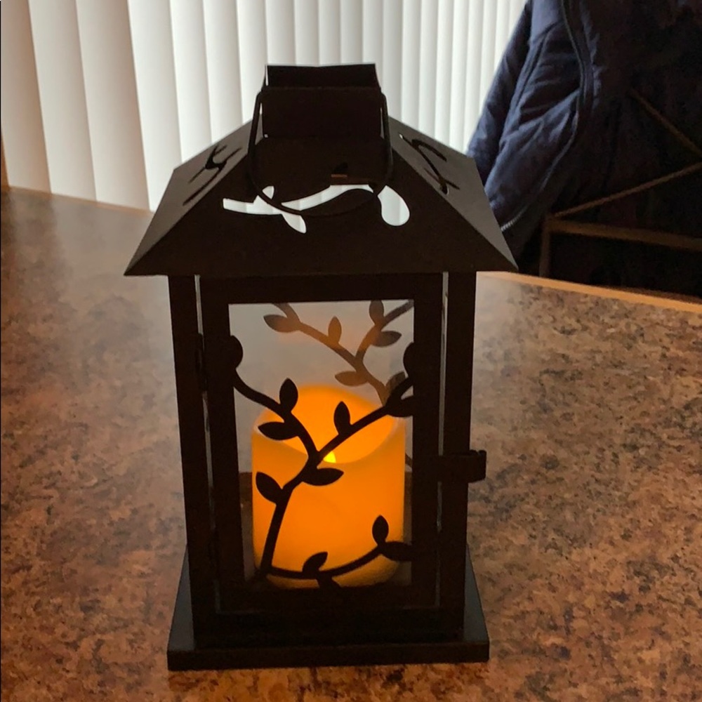 Decorative lantern with faux candle.